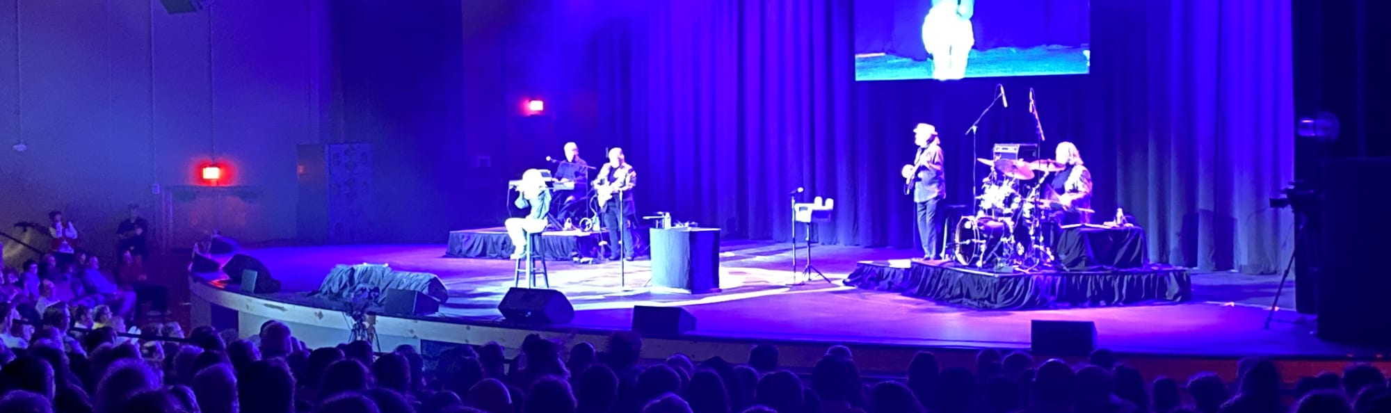 signer on stage in chair washed out by the lights Cheyenne